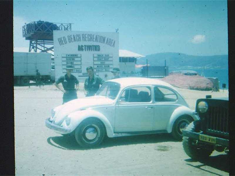Red Beach “used car lot”…NOT!  VW was probably staff car for USO personnel.